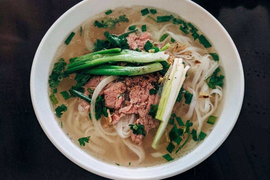 Pho soup with rice noodles, beef, and herbs