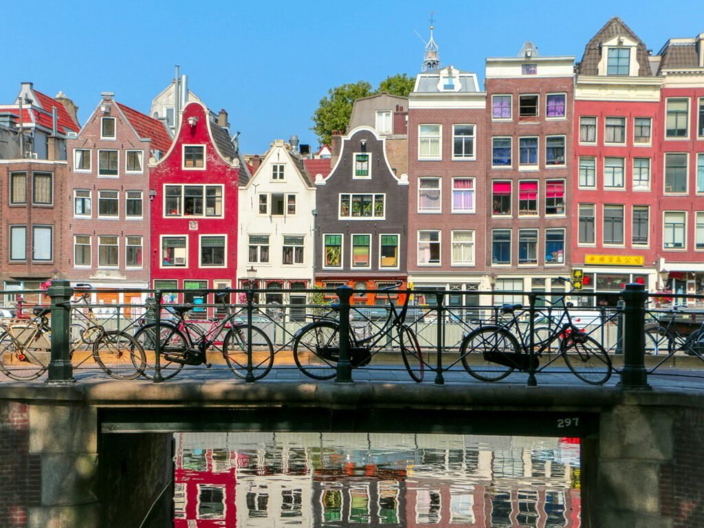 Amsterdam canal with colorful houses and bicycles