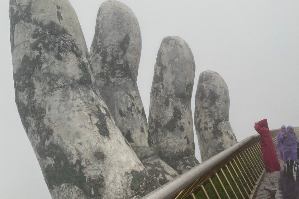 Golden Bridge in Ba Na Hills covered in mist during Christmas season, Da Nang, Vietnam
