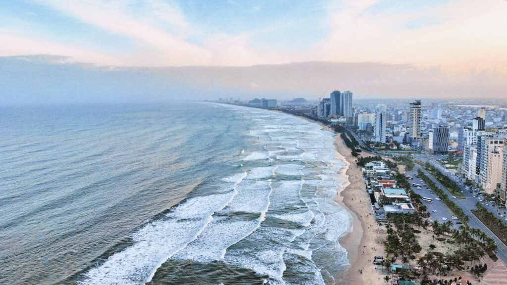 Da Nang beach with waves and city view