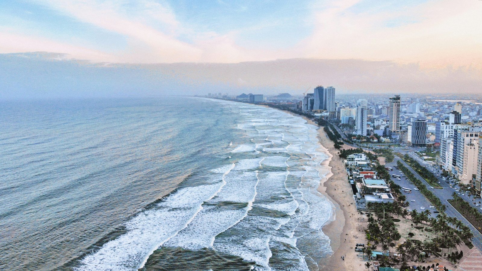 Da Nang beach with waves and city view