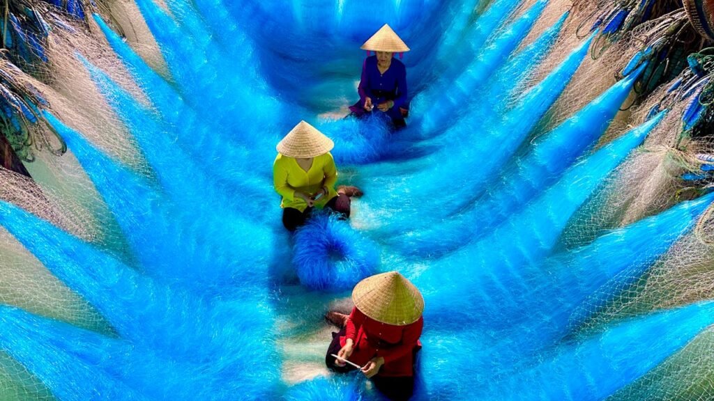 Colorful traditional fishing nets in Vietnam laid out for drying