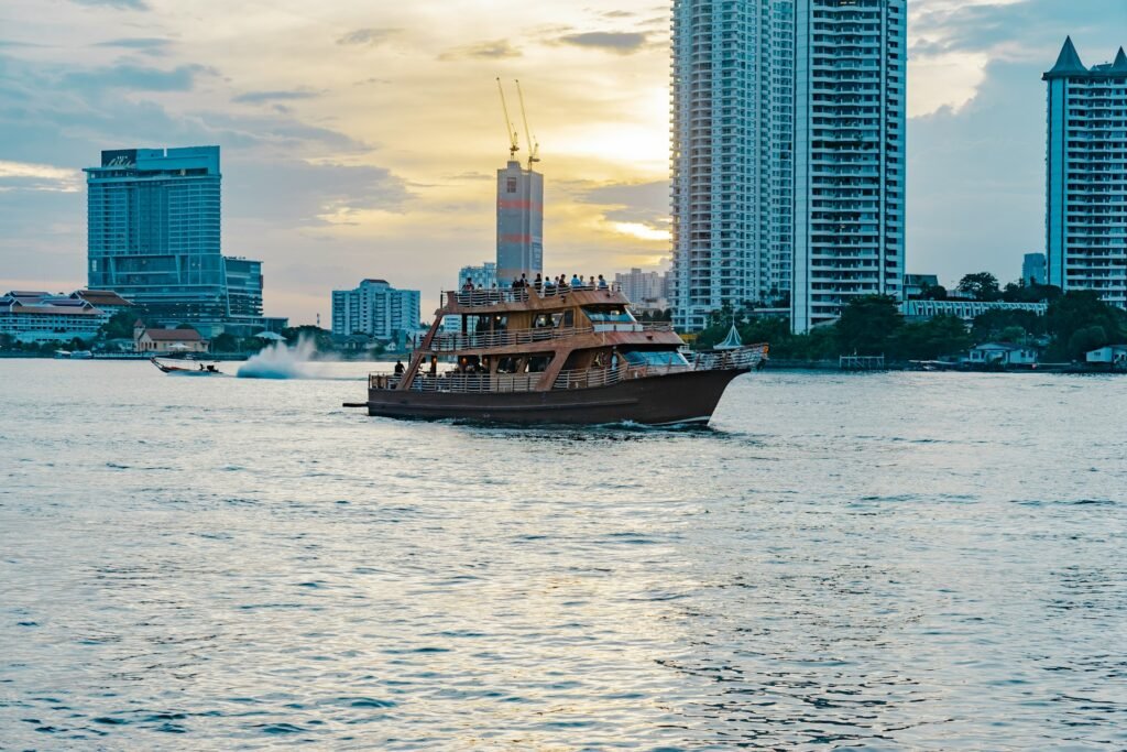 Boat on the Chao Phraya River in Bangkok with city skyline